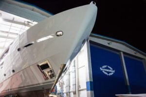 Yacht in a travel lift for hull service and antifouling